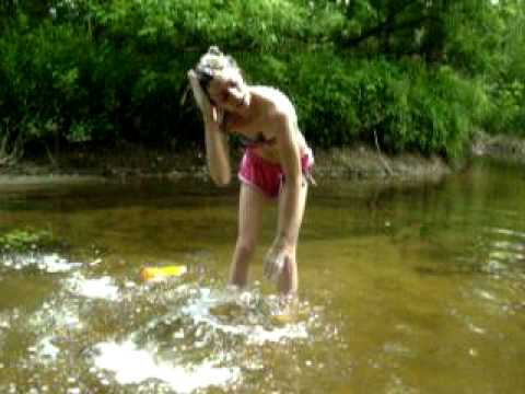 Naked and bathing in a stream and outdoors
